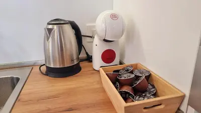 a kitchen counter with a coffee maker and a blender at Tehnoplus apartment in Budva