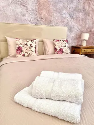a white bed with a white blanket on it at Apartment Studio Z&M in Kotor