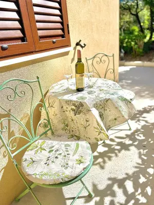 a table with two chairs and a bottle of wine at Apartment Studio Z&M in Kotor