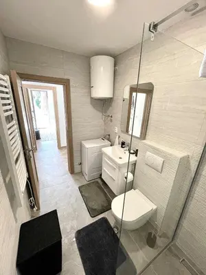 a bathroom with a toilet and a sink and a shower at Apartment Studio Z&M in Kotor
