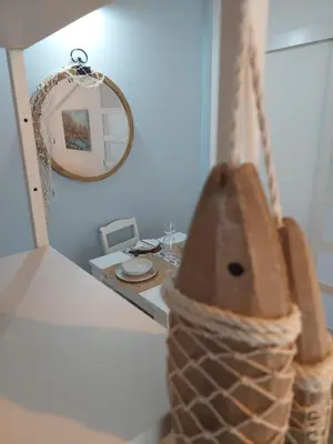 a mirror and a basket on a counter in a room at Bonaca Home Kotor in Kotor