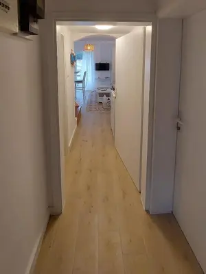 a hallway leading to a room with a hard wood floor at Bonaca Home Kotor in Kotor