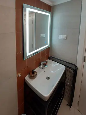 a bathroom with a white sink and a mirror at Bonaca Home Kotor in Kotor