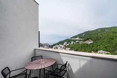 a balcony with a table and chairs and a view at Vuelo Sobre by In Property in Becici