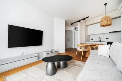 a living room with a couch and a table at Vuelo Sobre by In Property in Becici