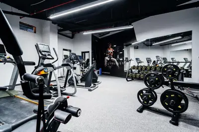 a gym with several treadmills and exercise machines at Vuelo Sobre by In Property in Becici