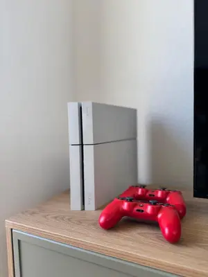 a red controller sitting on a shelf with a refrigerator at Olive Branch Studio Apartment Dobra Voda in Bar