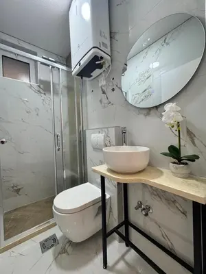 a bathroom with a toilet and a sink and a shower at Olive Branch Studio Apartment Dobra Voda in Bar