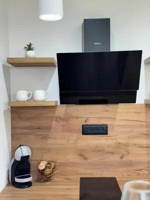 a flat screen tv sitting on top of a wooden table at Olive Branch Studio Apartment Dobra Voda in Bar