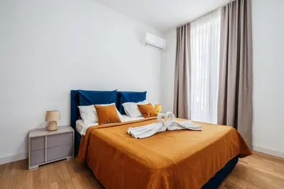 a bedroom with a bed with a bow on it at Luna skyline sea view apt in Budva