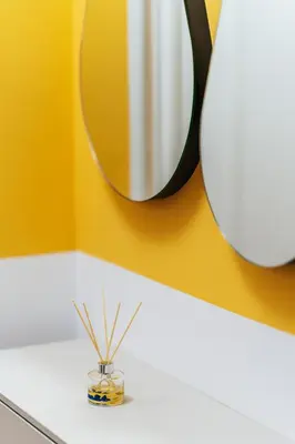 a mirror on a yellow wall above a bathroom sink at Luna skyline sea view apt in Budva