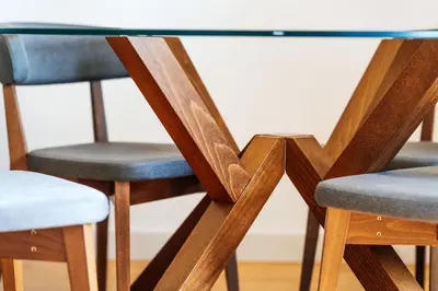 a glass dining table with two blue chairs at Luna skyline sea view apt in Budva