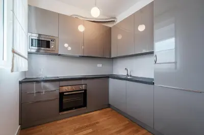 a kitchen with stainless steel appliances and wood floors at Luna skyline sea view apt in Budva