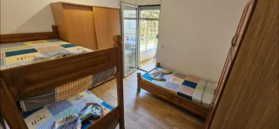 two bunk beds in a room with a window at Bulevar Apartments in Ulcinj