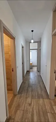 an empty room with a hallway with wood floors at Bulevar Apartments in Ulcinj