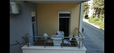 a balcony with a table and toilets on a house at Bulevar Apartments in Ulcinj