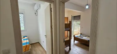 a hallway with a room with a bed and a window at Bulevar Apartments in Ulcinj