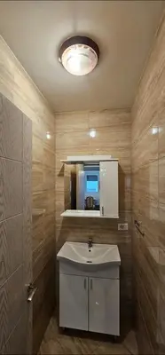 a bathroom with a white sink and a mirror at Bulevar Apartments in Ulcinj