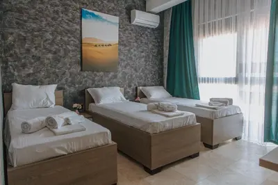 a hotel room with two beds and a window at Hermosa Hotel in Donji Štoj