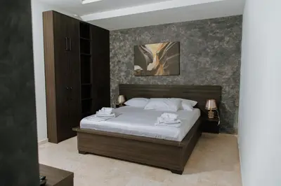 a bedroom with a bed with white towels on it at Hermosa Hotel in Donji Štoj