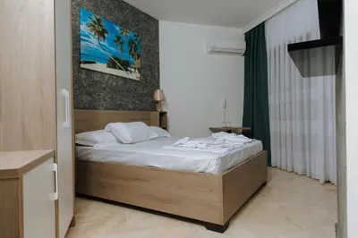 a bedroom with a bed in a room at Hermosa Hotel in Donji Štoj