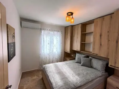 a small bedroom with a bed and a window at Green Castle in Kunje