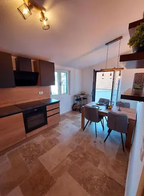a kitchen with a table and a dining room at Green Castle in Kunje