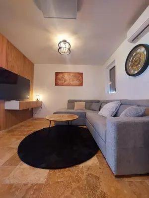 a living room with a couch and a table at Green Castle in Kunje