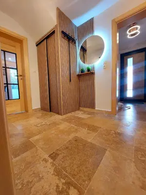an empty room with a mirror and a hallway at Green Castle in Kunje