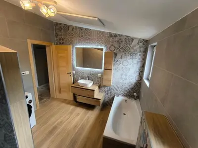a bathroom with a sink and a toilet and a tub at Green Castle in Kunje