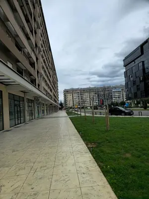 an empty sidewalk in front of a building at Central Point apartment in Podgorica