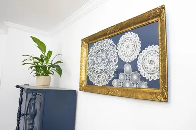 a framed picture on a wall with a plant on a table at Glanz Antique Paradise near the Sea in Kotor