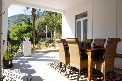 a patio with a wooden table and chairs at Glanz Antique Paradise near the Sea in Kotor