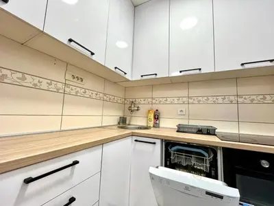a kitchen with white cabinets and a dishwasher at Three bedroom apartment Budva in Budva