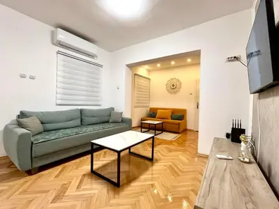 a living room with a couch and a table at Three bedroom apartment Budva in Budva