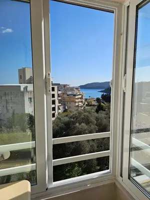 a window with a view of the water at Tirke Apartment in Becici