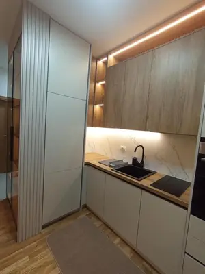 a kitchen with white cabinets and a sink at Orzeja apartments in Ulcinj