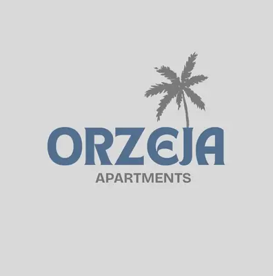 a palm tree and the ocrila apartments logo at Orzeja apartments in Ulcinj