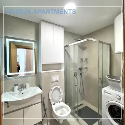 a bathroom with a shower and a toilet and a sink at Orzeja apartments in Ulcinj