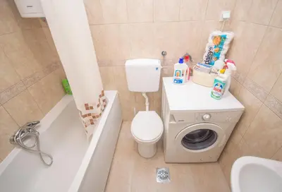 a bathroom with a toilet and a sink and a washing machine at Apartment Nikolic Kotor in Kotor