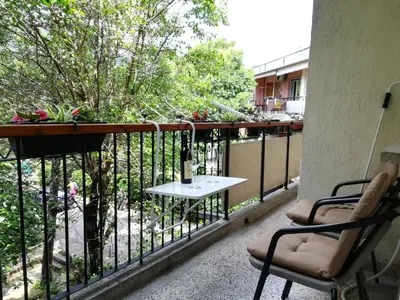 a balcony with two chairs and a table on it at Apartment Nikolic Kotor in Kotor