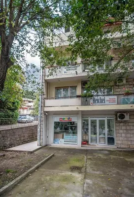 a building with a store in front of it at Apartment Nikolic Kotor in Kotor