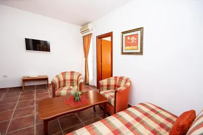 a living room with a couch and a table and chairs at Villa Iper in Budva
