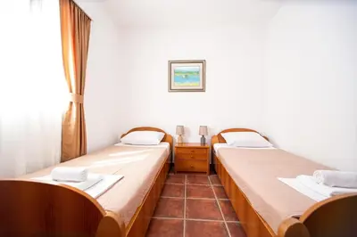 two beds sitting next to each other in a room at Villa Iper in Budva
