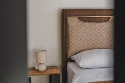 a bedroom with a bed and a table with a lamp at B&O Seaview in Bar