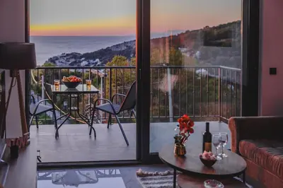 a living room with a balcony with a view of the ocean at B&O Seaview in Bar