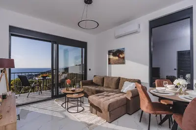 a living room with a couch and a table at B&O Seaview in Bar