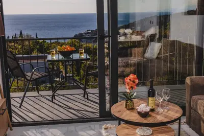 a balcony with a table and a view of the ocean at B&O Seaview in Bar