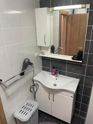 a bathroom with a sink and a mirror at Apartment with large living room in Bar