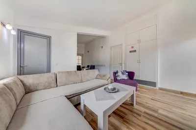 a living room with a couch and a table at Delfin Apartments in Sutomore